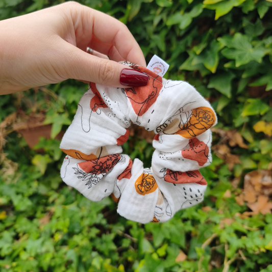 Vrouwelijke, bloemige scrunchie in koper